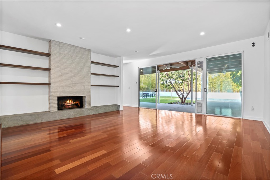 16301 Meadow Ridge Road West Encino, CA 91436 - Photo 3 of 33 a view of empty room with wooden floor and fireplace