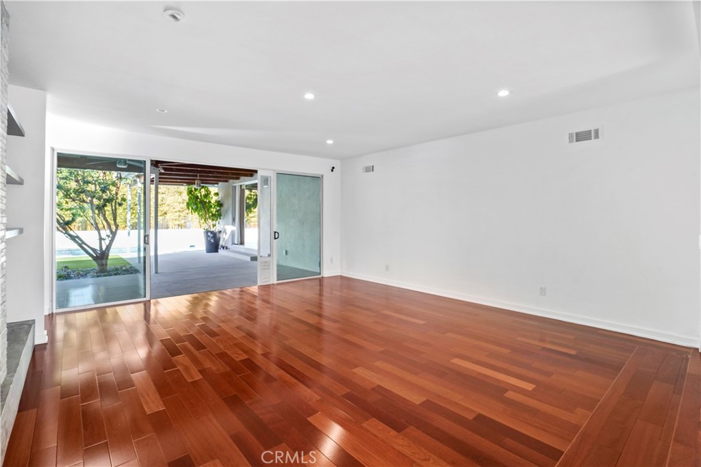 16301 Meadow Ridge Road West Encino, CA 91436 - Photo 6 of 33 a view of an empty room with wooden floor and a window