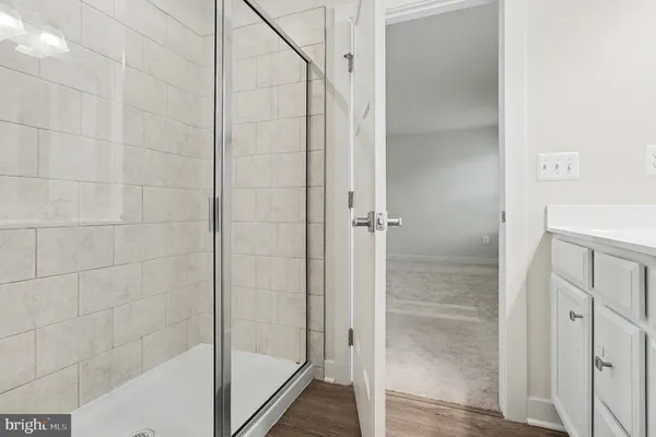 a bathroom with a glass shower door