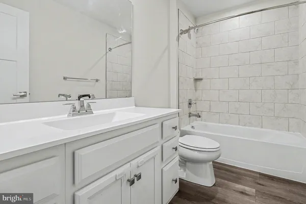 a bathroom with a sink a toilet and a bathtub