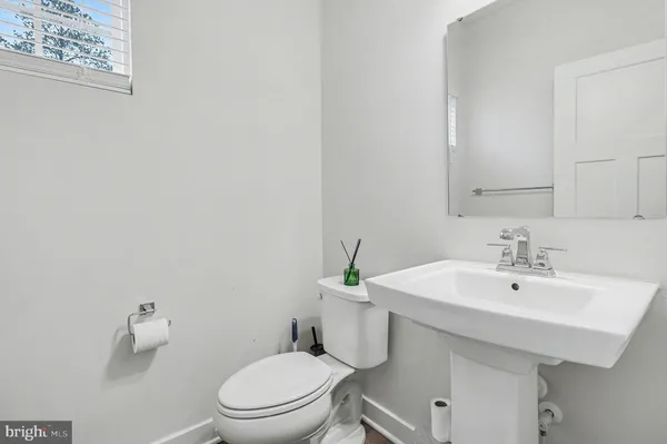 a white toilet sitting next to a bathroom sink