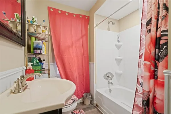 a bathroom with a bath tub and a sink