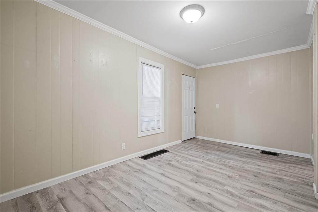 246 Colfax Street Springdale, PA 15144 - Photo 4 of 17 an empty room with wooden floor and windows