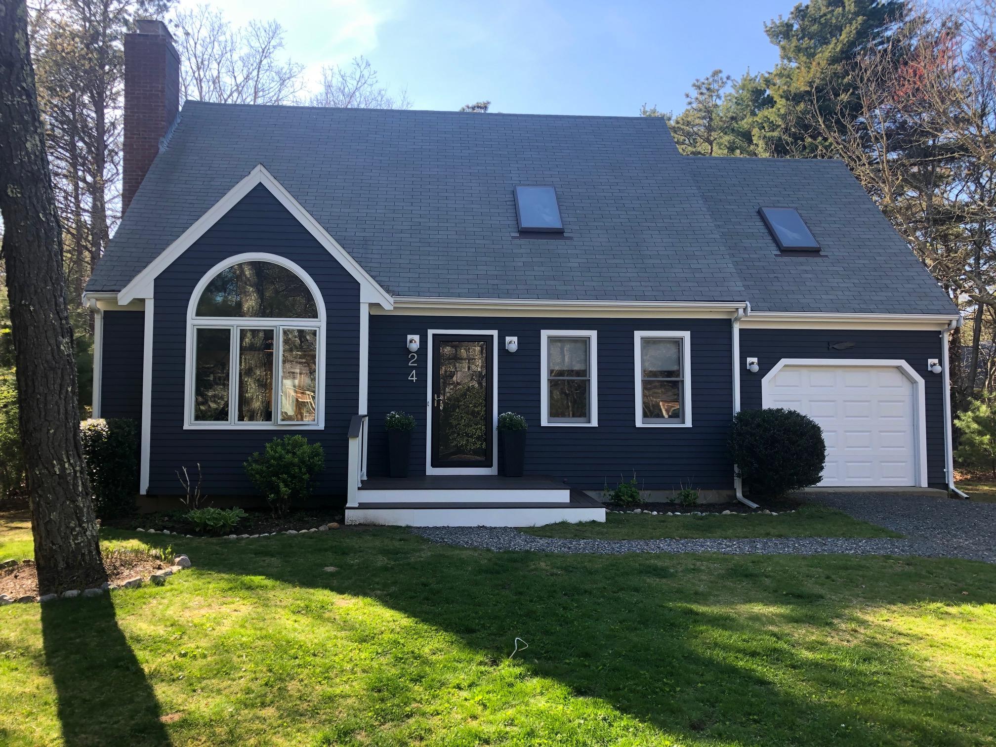 a front view of a house with garden