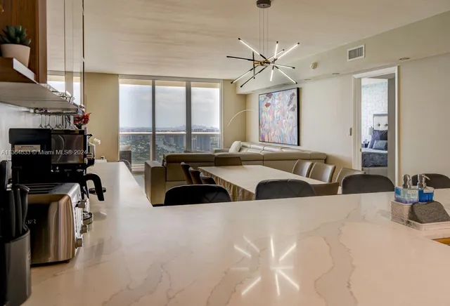 a large bedroom with a large bed and a flat tv screen