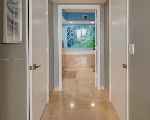 a view of a hallway with a glass door and a yard