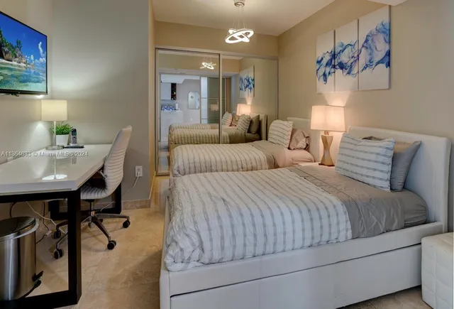 a bedroom with bed and a table