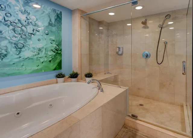 a bathroom with a bathtub and a shower