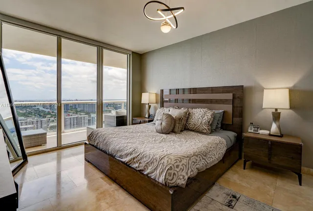 a bedroom with a large bed and a large window