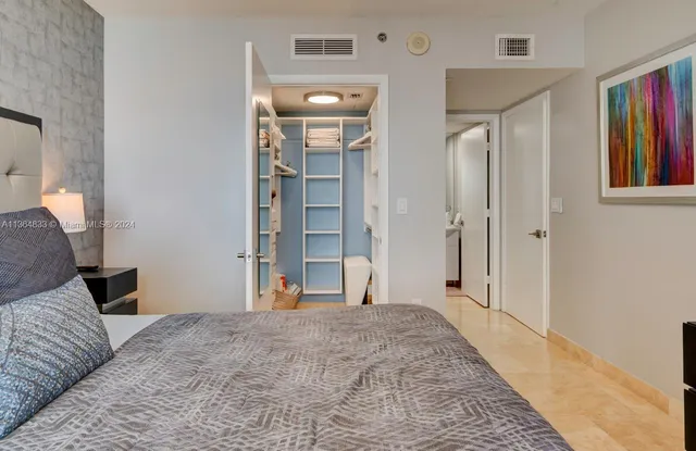 a bedroom with a bed and a mirror