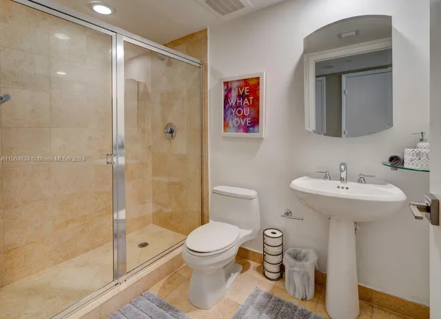 a bathroom with a toilet sink and shower