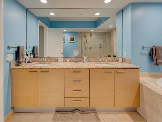 a bathroom with a sink vanity and mirror
