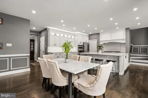 a kitchen with kitchen island a large window and cabinets