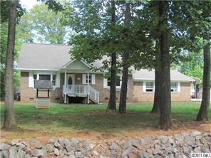 a front view of a house with a yard patio and fire pit