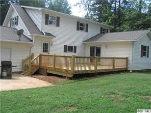 8267 Normandy Road Denver, NC 28037 - Photo 14 of 16 a view of a house with a backyard and porch