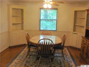 8267 Normandy Road Denver, NC 28037 - Photo 6 of 16 a view of a dining room with furniture and wooden floor
