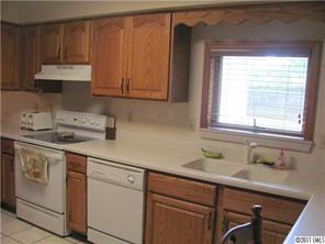 8267 Normandy Road Denver, NC 28037 - Photo 7 of 16 a kitchen with stainless steel appliances granite countertop a sink and a white cabinets