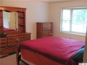 8267 Normandy Road Denver, NC 28037 - Photo 10 of 16 a bedroom with a bed and a dresser