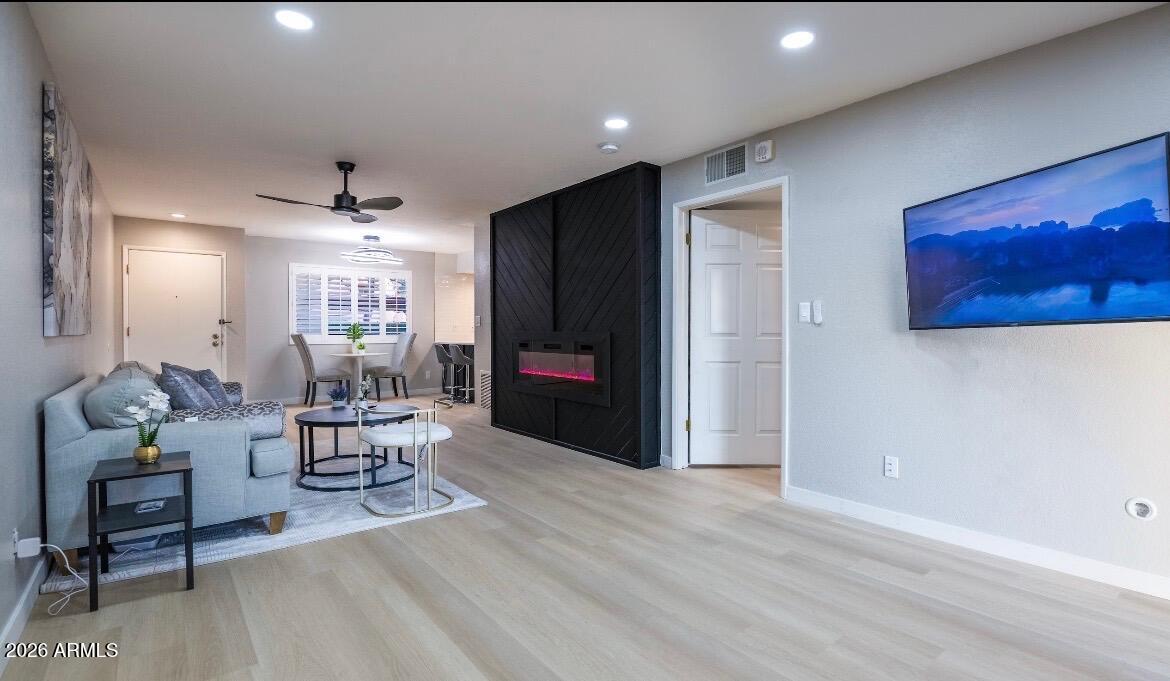 4303 East Cactus Road, Unit 128 Phoenix, AZ 85032 - Photo 13 of 39 a living room with furniture and a wooden floor