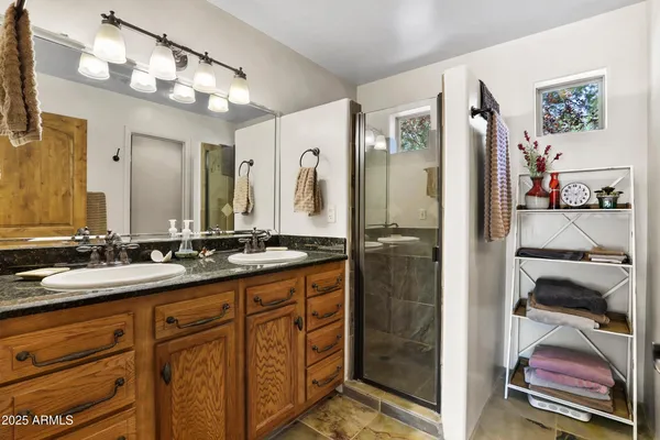 a bathroom with a double vanity sink and mirror
