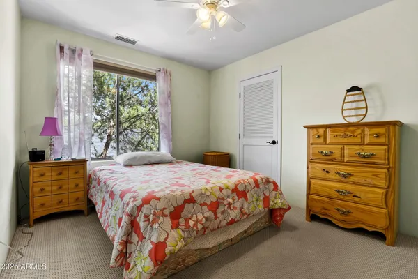 a bedroom with a bed and a dresser