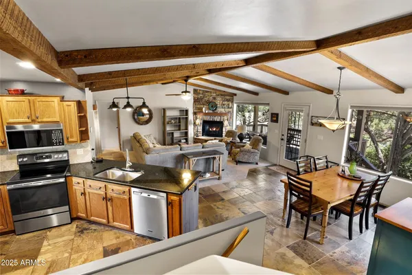 a kitchen with stainless steel appliances granite countertop a stove and a refrigerator
