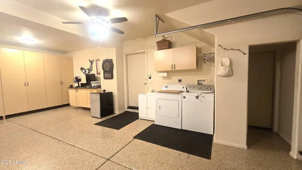 a kitchen with white cabinets and white appliances