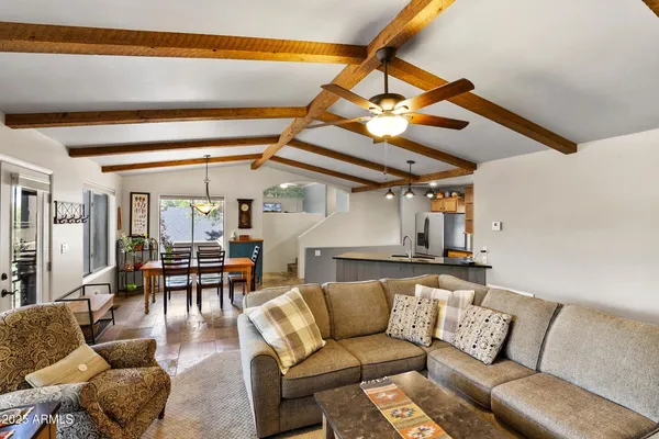 a living room with furniture and kitchen view