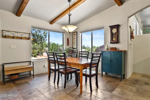 a dining room with furniture a chandelier and window