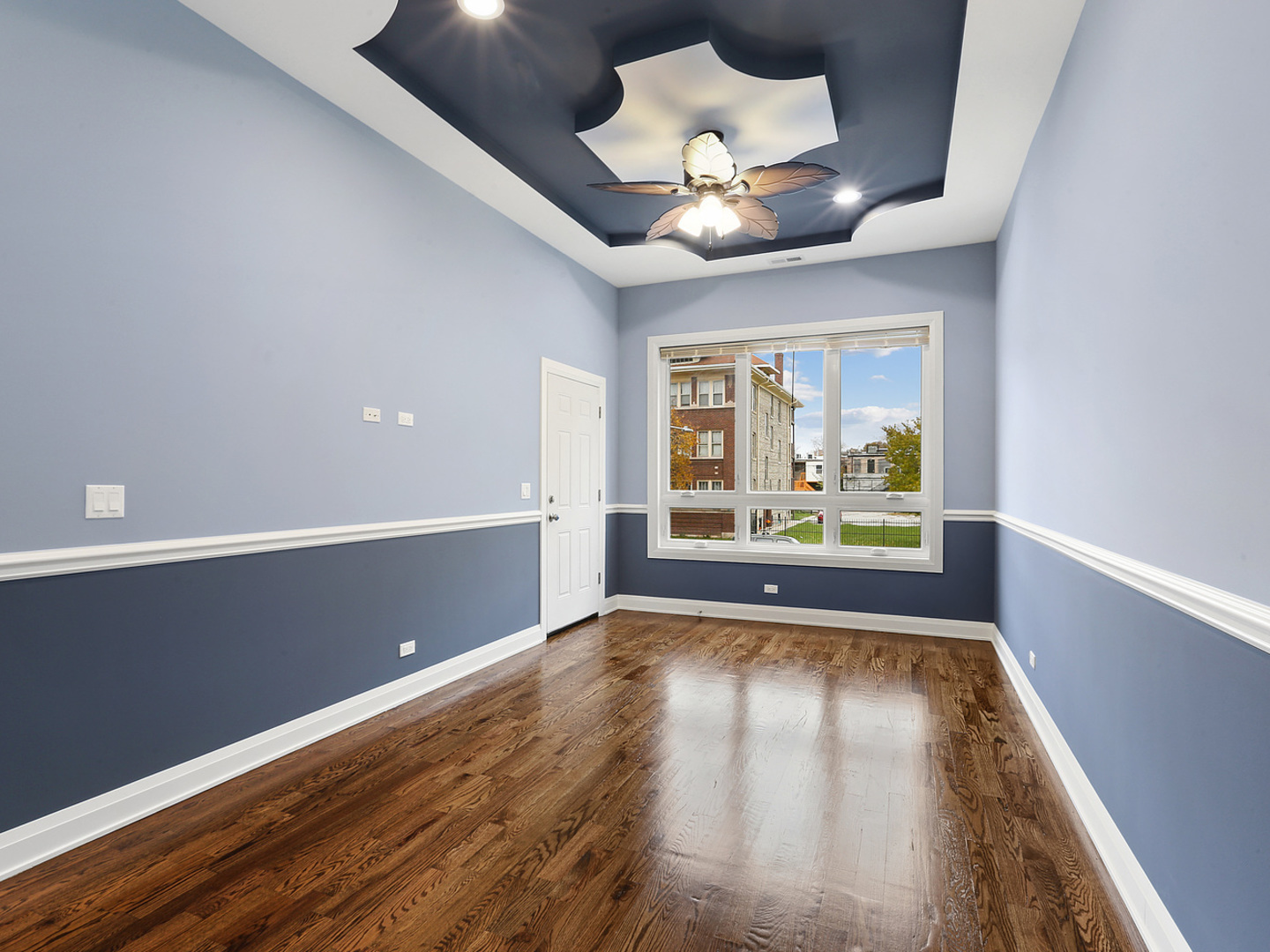 5939 West Superior Street, Unit 1 Chicago, IL 60644 - Photo 3 of 12 an empty room with wooden floor and windows