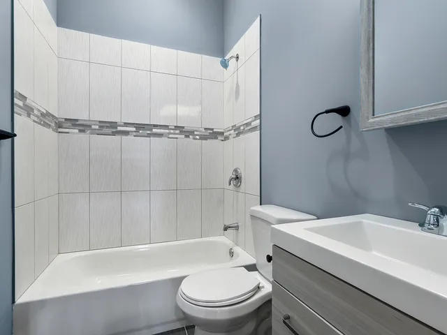 a bathroom with a toilet a sink and bathtub