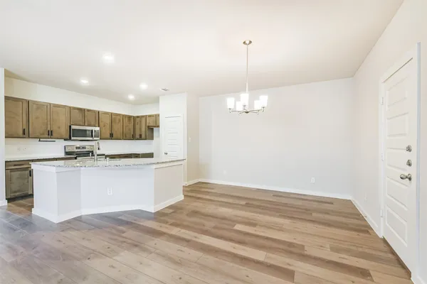 a kitchen with stainless steel appliances granite countertop a sink refrigerator and cabinets
