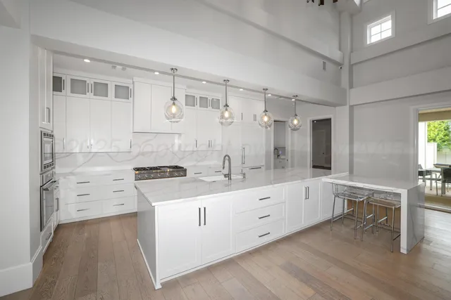 an aerial view of a house with a garden and lake view