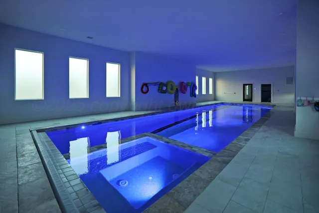 a spacious bathroom with a double vanity sink a mirror and a bathtub