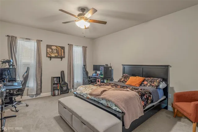 a bedroom with a bed a chair and a chandelier