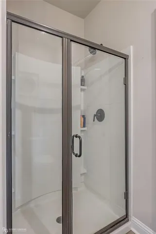 a bathroom with a glass shower door