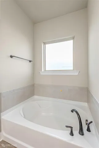a white bath tub sitting next to a window
