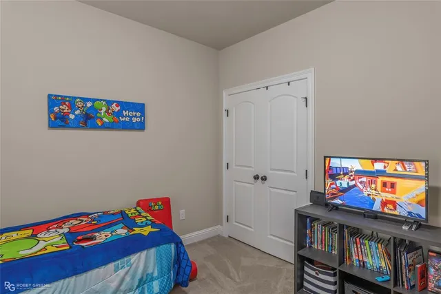 a bedroom with a bed and a book shelf
