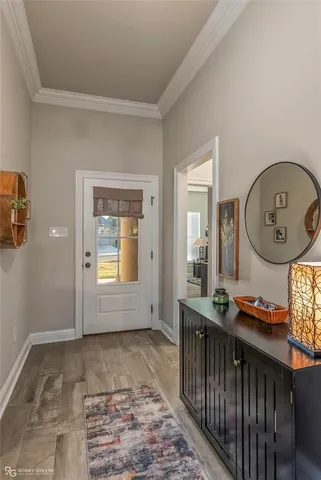 a view of an entryway with wooden floor