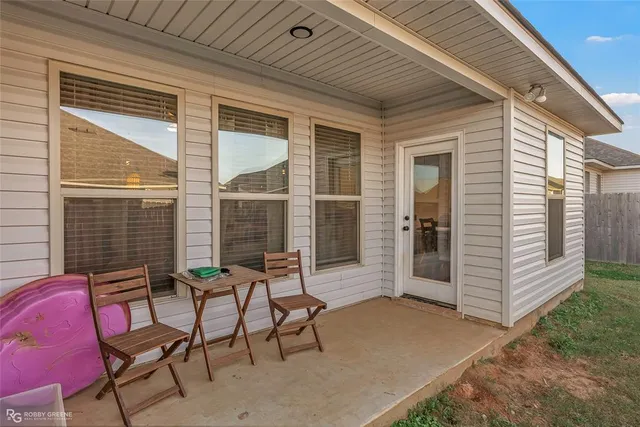 a view of two chairs in the patio