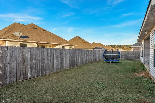 a backyard of a house with wooden fence