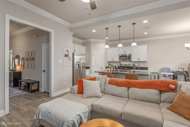 a living room with furniture kitchen and a chandelier