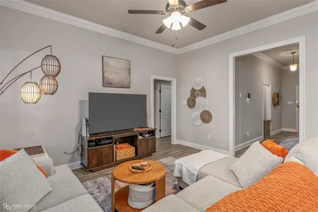 a living room with furniture and a flat screen tv