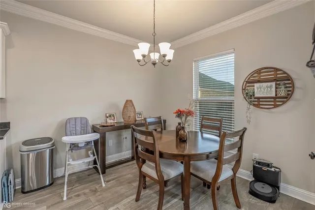 a view of a dining room with furniture and chandelier