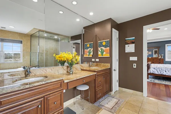 a bathroom with a sink a mirror and shower