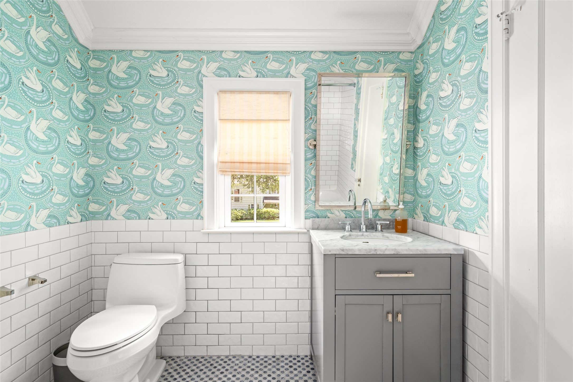 3784 Ingold Street Houston, TX 77005 - Photo 32 of 50 Secondary bathroom is such a treat with swan wallpaper, subway tile, and sink space.