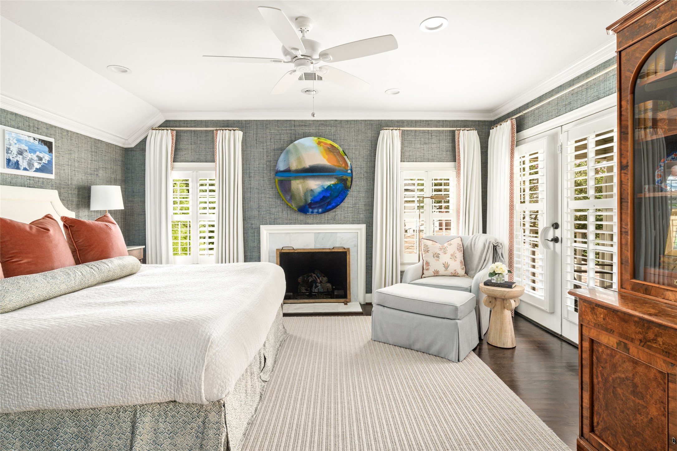 3784 Ingold Street Houston, TX 77005 - Photo 35 of 50 Primary bedroom is cozy with fireplace, dreamy wallpaper, wood floors and a fabulous balcony overlooking the backyard.