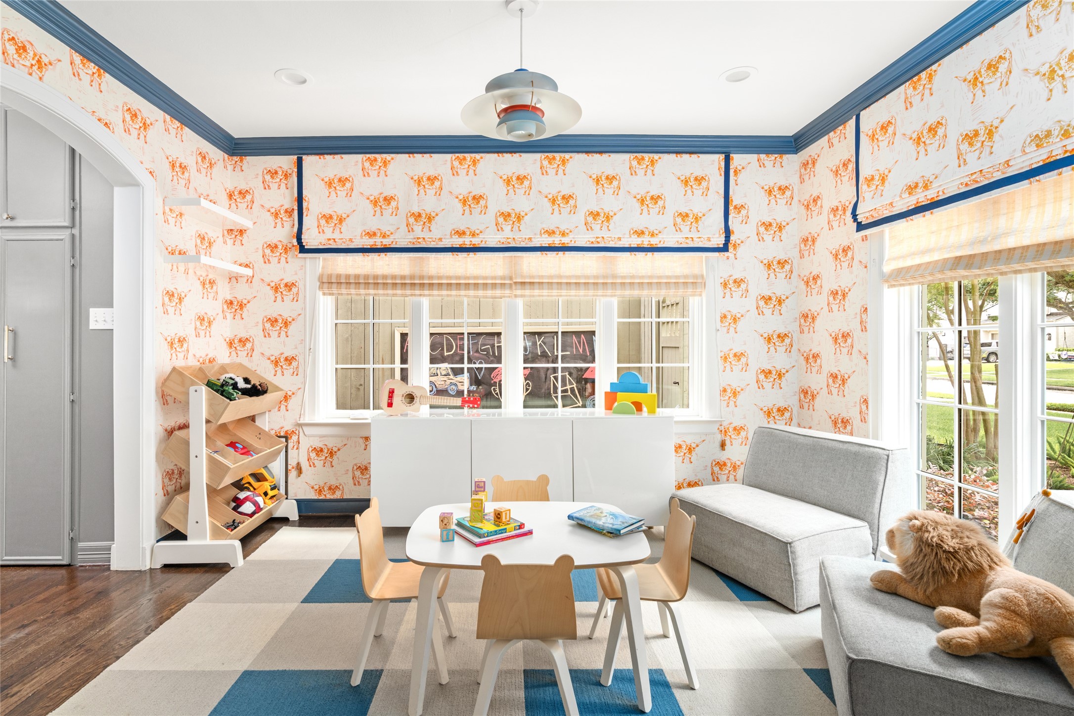 3784 Ingold Street Houston, TX 77005 - Photo 7 of 50 Off the dining area is this adorable play room adorned with cheeky wallpaper and contrasting crown molding.