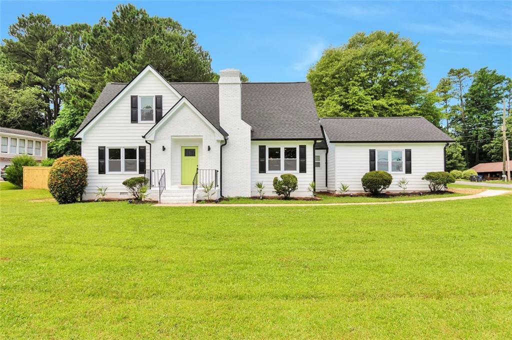 237 Rockbridge Road Southwest Lilburn, GA 30047 - Photo 1 of 1 a front view of a house with garden