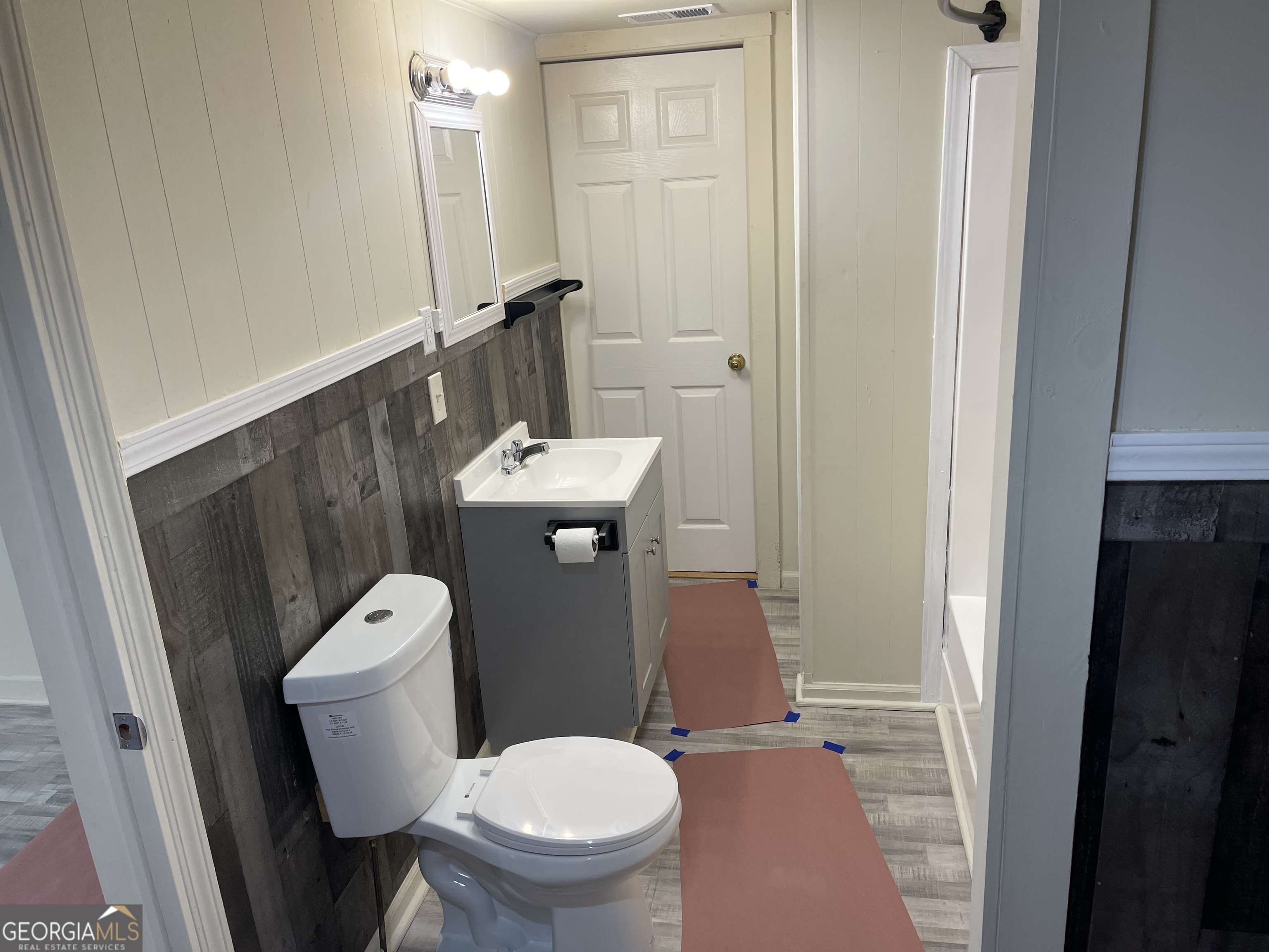 478 South Pond Street Toccoa, GA 30577 - Photo 16 of 46 a white toilet sitting next to a bathroom sink and a mirror